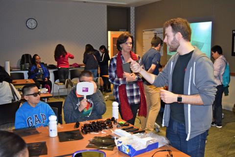 MSE Ph.D. student Alex Bryant (right) teaches students about optical polarization and how it relates to items like sunglasses and 3D movies.